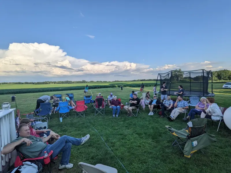 A group gathered on lawn chairs outdoors for Bible study