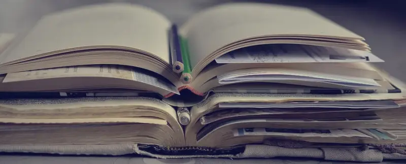 A stack of well-used Bibles and books