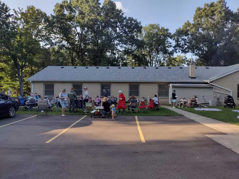 The Grace Baptist Church building and parking lot surrounded by trees