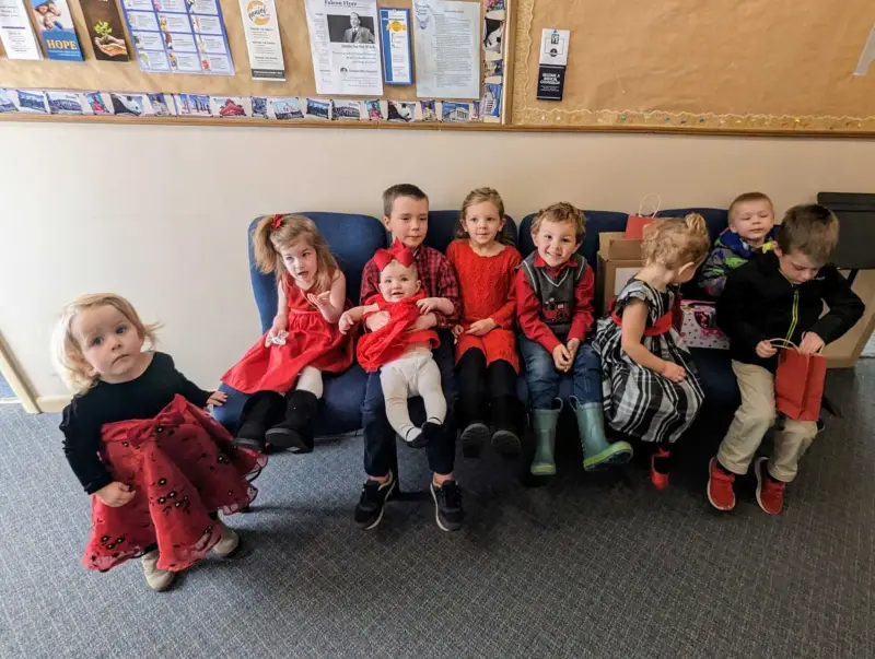 Children of the Grace Homeschool Co-Op sitting together on a couch