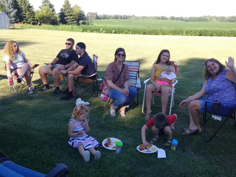 Church families enjoying a picnic together on the grass