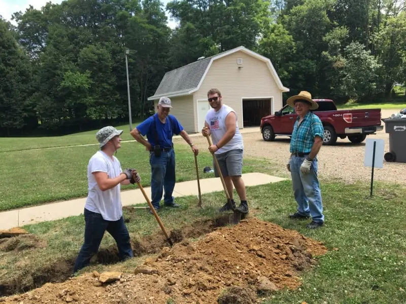 Church members digging and working on the church grounds